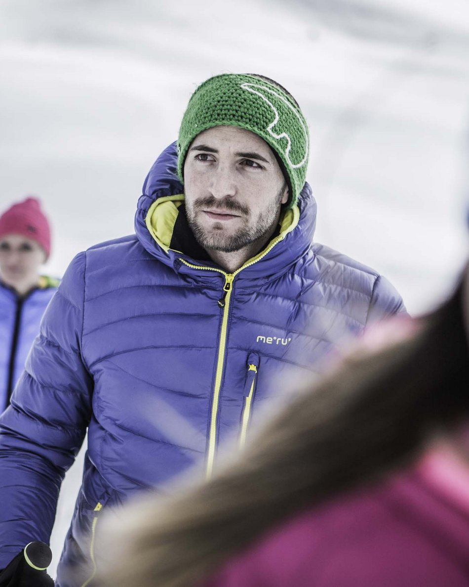 Your hotel in Val Pusteria/Pustertal: Olangerhof People skiing wearing winter clothes on white snow