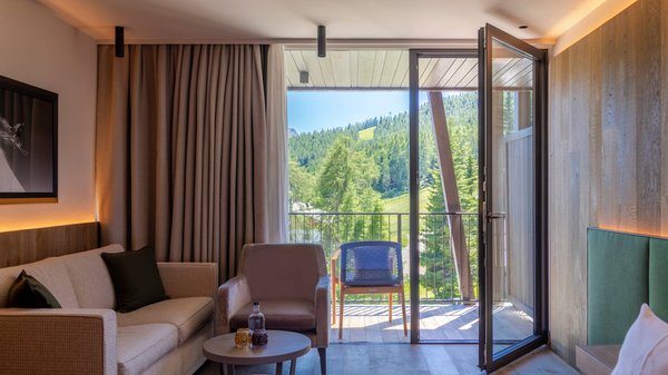 Dein Hotel in Olang: Willkommen im Olangerhof! Hotelzimmer mit offenem Balkon und Blick auf grüne Berge